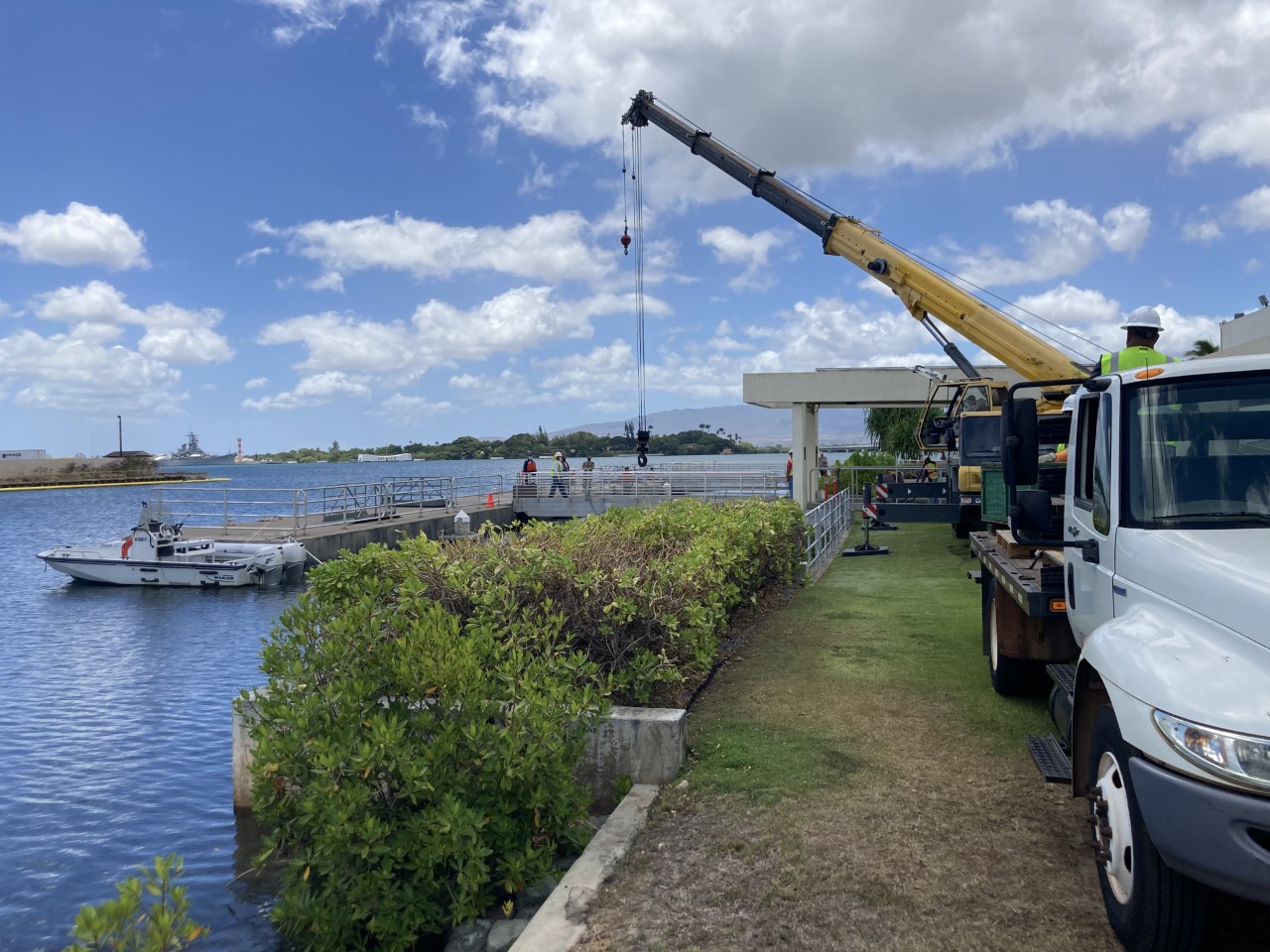 Looking out towards Pearl Harbor, in the foreground a vehicle based crane is parked along side the shoreside dock, as NPS and Navy staff assess the situation.