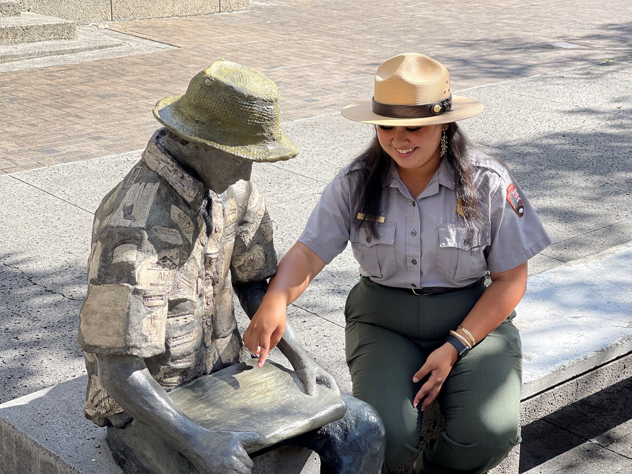 Park Ranger points to a statues map