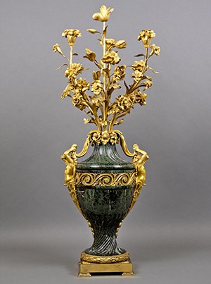 A green marble and gilt candelabrum.