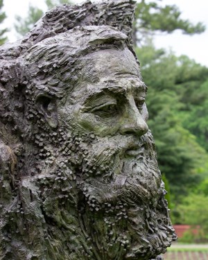 A bronze bust of a male head and shoulders.