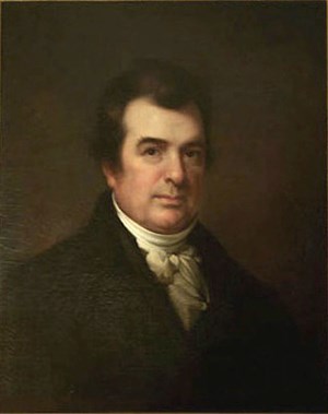 A three quarter portrait of a man wearing a coat.