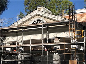 A building under renovation covered in scaffolding.