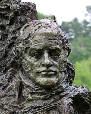 A bronze bust of a male head and shoulders.