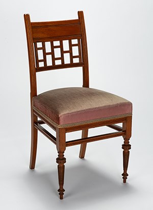 A chair with pierced back and upholstered seat.