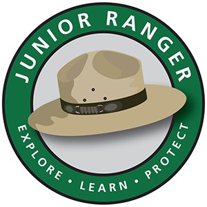 A graphic image of a ranger hat in a round band containing the words Junior Ranger, Explore, Learn, Connect.