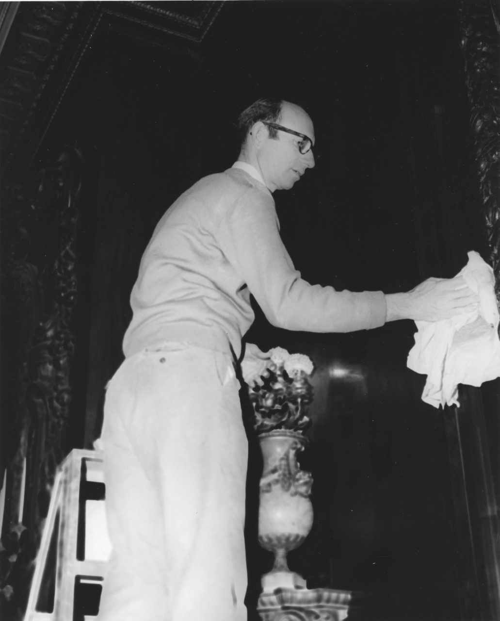 1971 photo of Donald Borquist in the living room of the Vanderbilt Mansion (NPS Photo) Man on a ladder dusting
