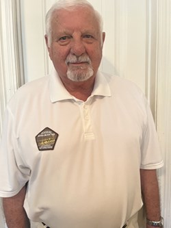 A man in a white polo shirt.