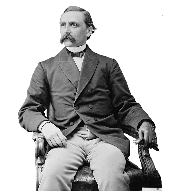 A black and white image of a man with mustache sitting in a chair.