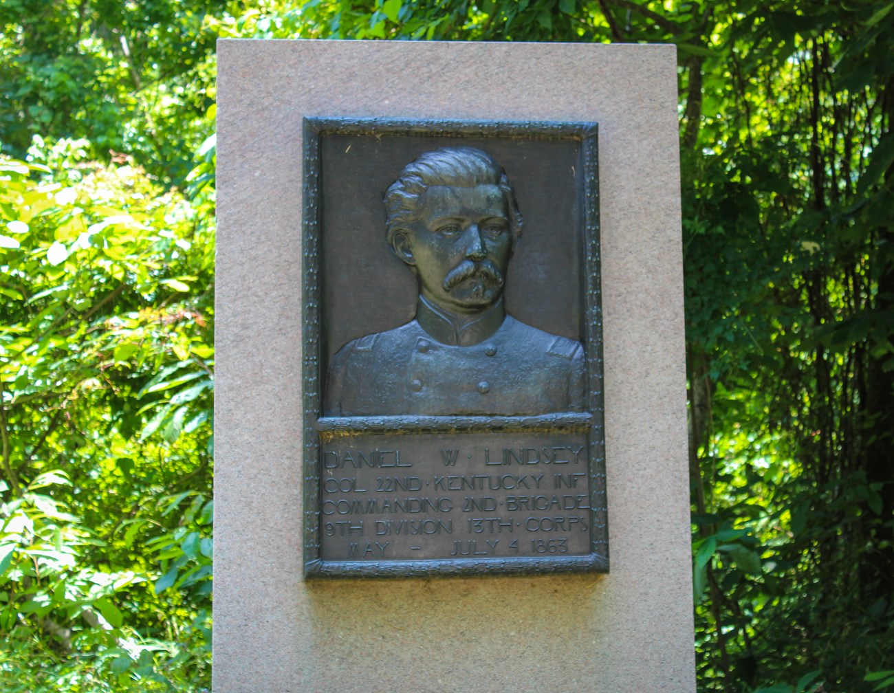 A bronze relief portrait of man dressed in uniform