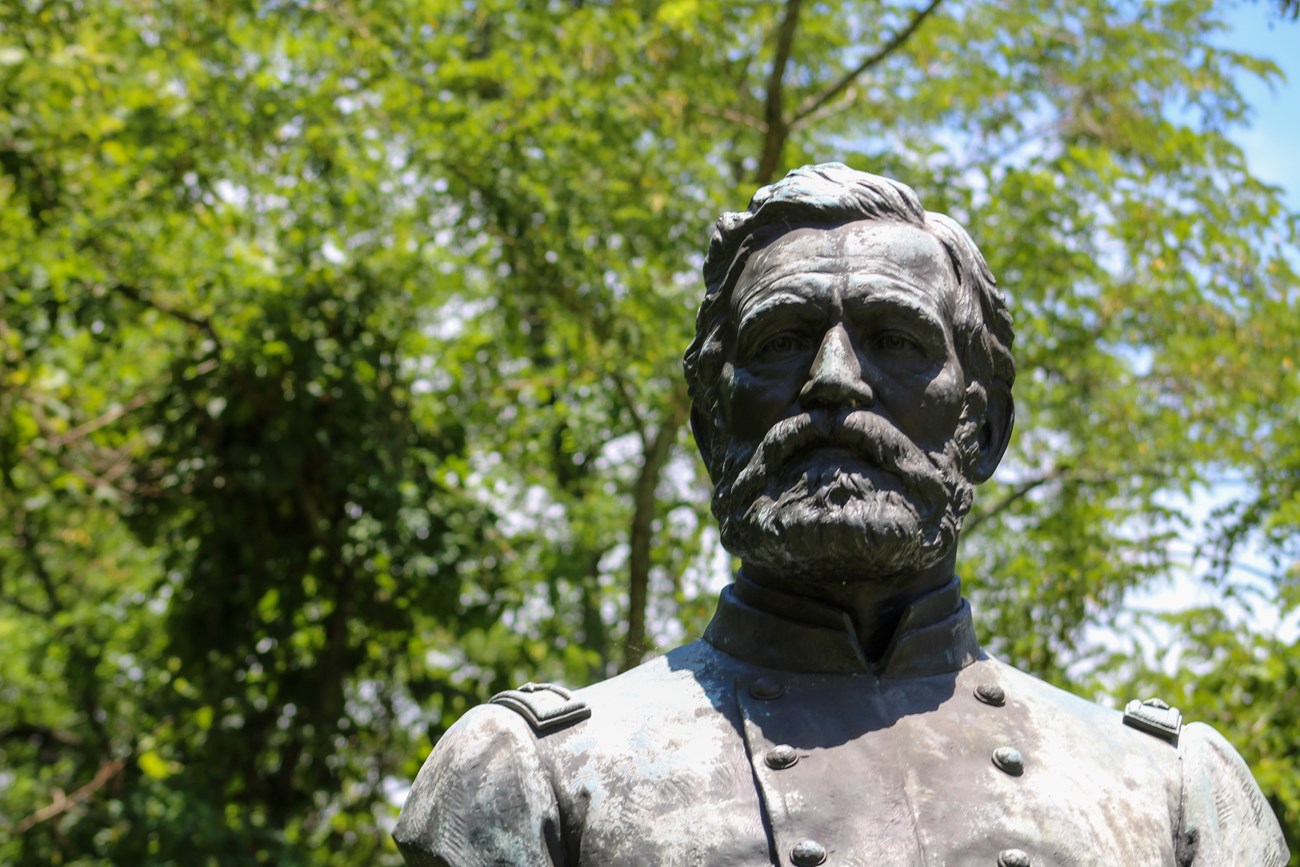 A bronze bust sculpture of a man in uniform