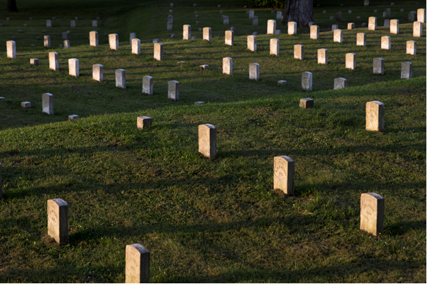 Headstones Vicksburg National Cemetery Rows of white upright off-white colored stones in green grassy field with two terraces.