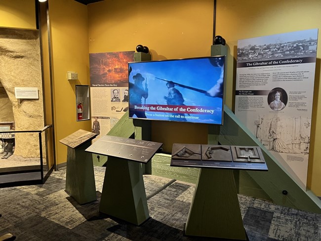 An interactive map display with a TV and info panels