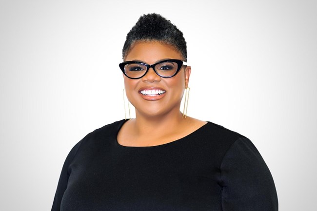 African American women wearing black framed glasses and a black top