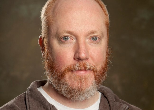 A bald man with red beard.