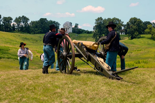 Living Historians Leaning on a cannon