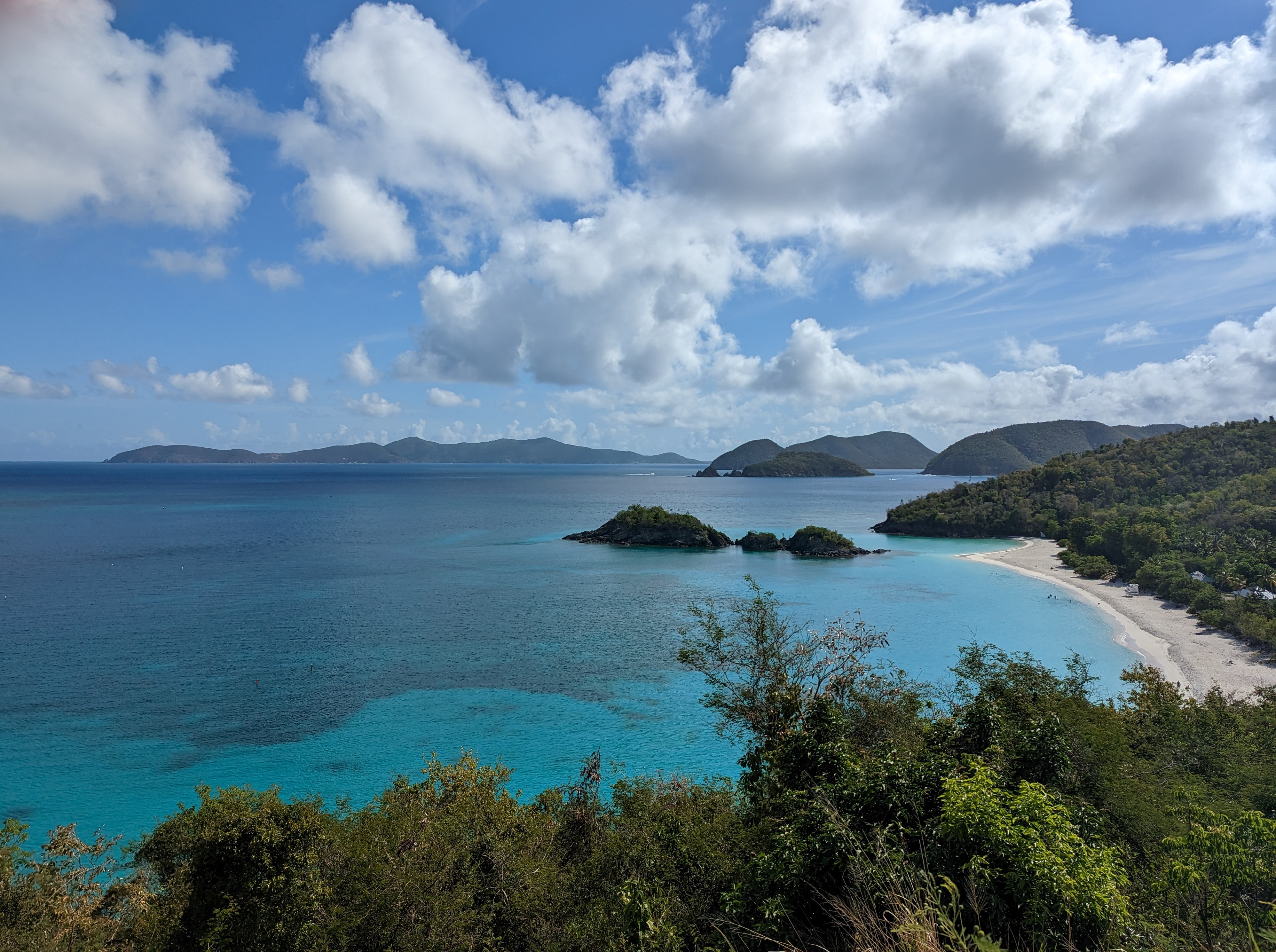 Trunk Bay Overlook Image of Trunk Bay with white sand, green hills and blue water.