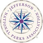 A round logo with a Blue, Purple, and White compass rose surrounded by text reading "Jefferson National Parks Association".