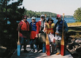 Park volunteers stand with canoe paddles in hand after leading a guided North Canoe trip in the park. Park volunteers stand with canoe paddles in hand after leading a guided North Canoe trip in the park.