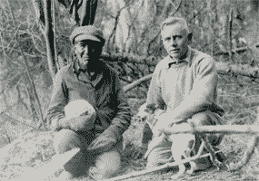 Ernest Oberholtzer with dog Skippy and Billy Maggie holding cabbage.
