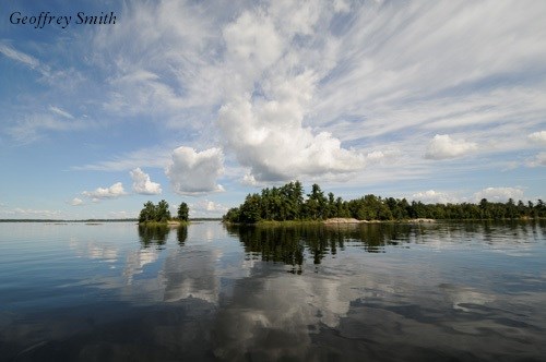 Lake with island and treeline Lake with island and treeline