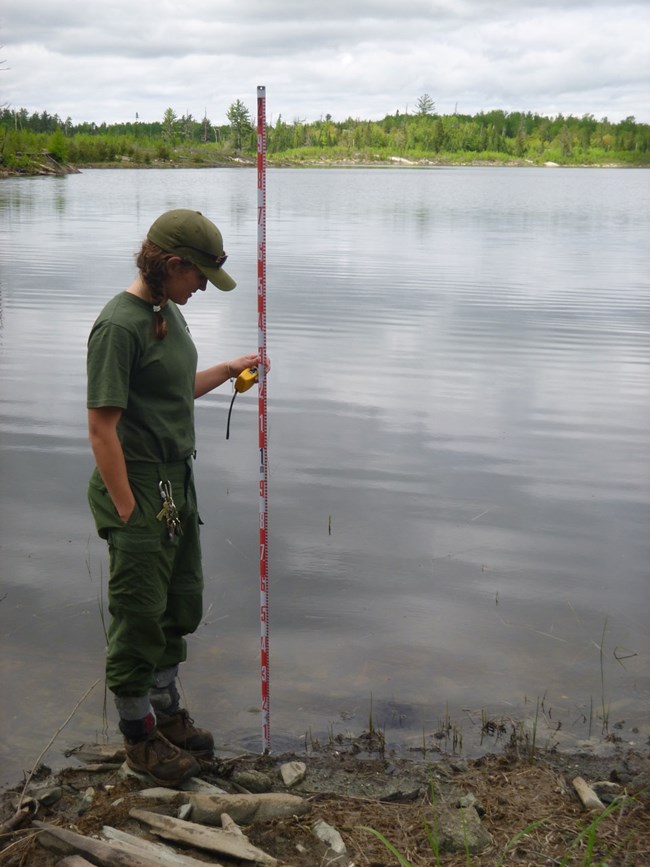 Aquatic staff taking measurements of the shoreline Aquatic staff taking measurements of the shoreline