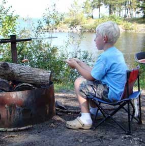 Roasting a hot dog over a campfire