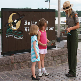Two girls are sworn in as Junior Rangers by a Park Ranger. Two girls are sworn in as Junior Rangers by a Park Ranger.