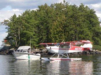 A park boat and plane floating on water.