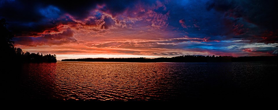 A multitude of colors reflect between the clouds and waters of Lake Kabetogama as the sun sets.