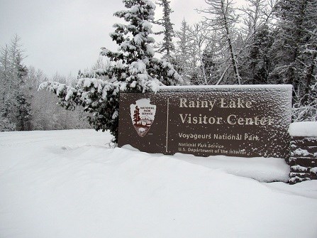 Rainy Lake Visitor Center Sign covered in snow. Rainy Lake Visitor Center Sign covered in snow.