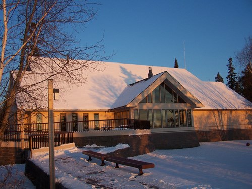 Lakeside of the Rainy Lake Visitor Center with the sunrise on it