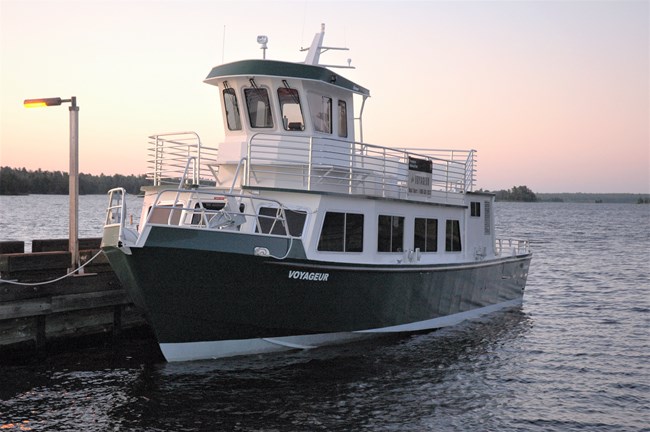 Voyageur tour boat on Rainy Lake before sunset