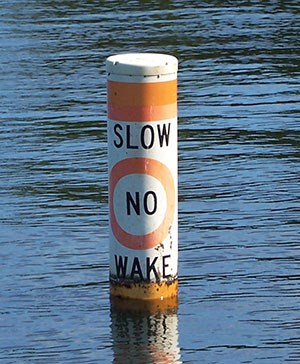 Buoy in water with the word: "Slow, No Wake".