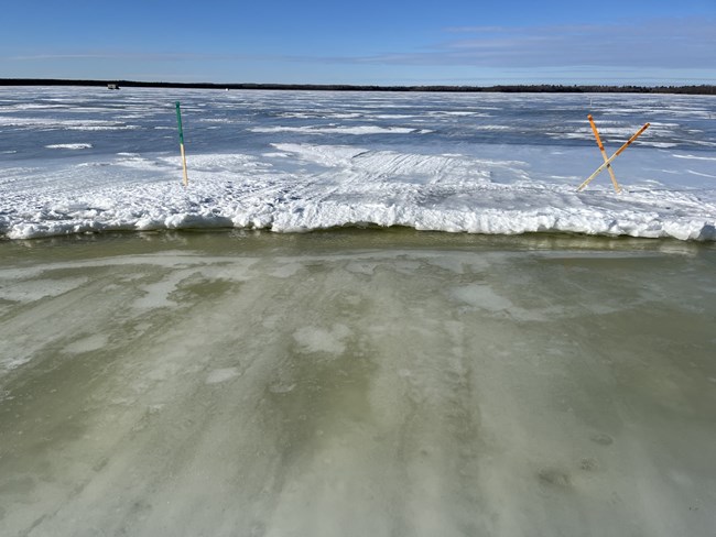 slush and open water along deep pressure ridge on frozen lake trail