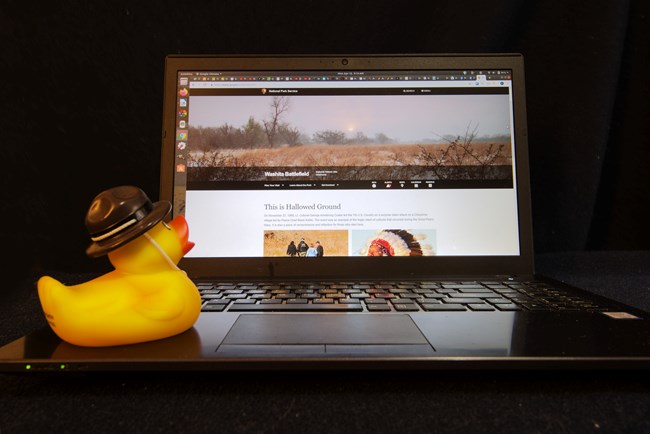 a rubber duck in a ranger hat on a computer