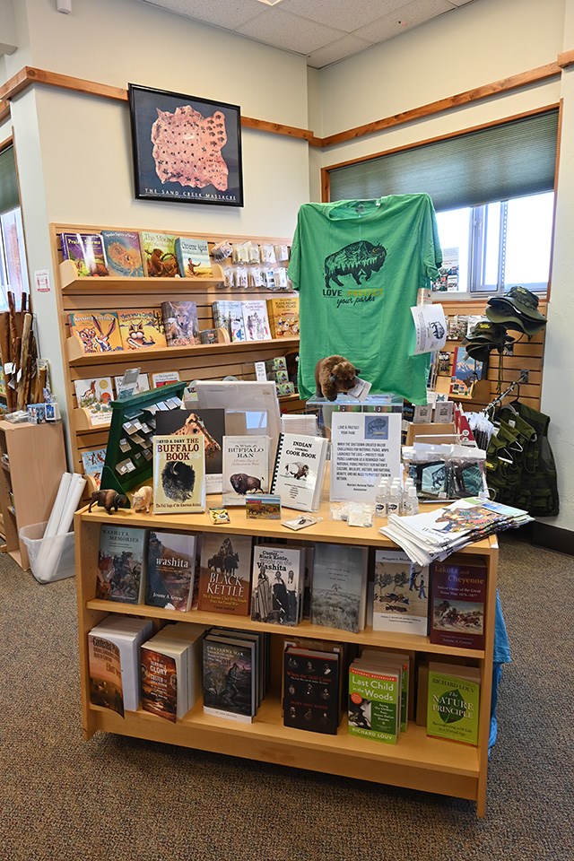 Book shelves and displays containing books, clothing, and souvenirs.