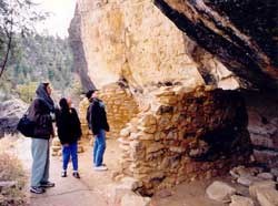 Visitors at cliff dwelling on Island Trail