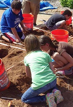 Students digging for replica fossils. Students digging for replica fossils.