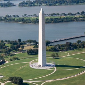Aerial photograph of the Washington Monument shows the surrounding grounds, the Tidal Basin, and the Potomac River.