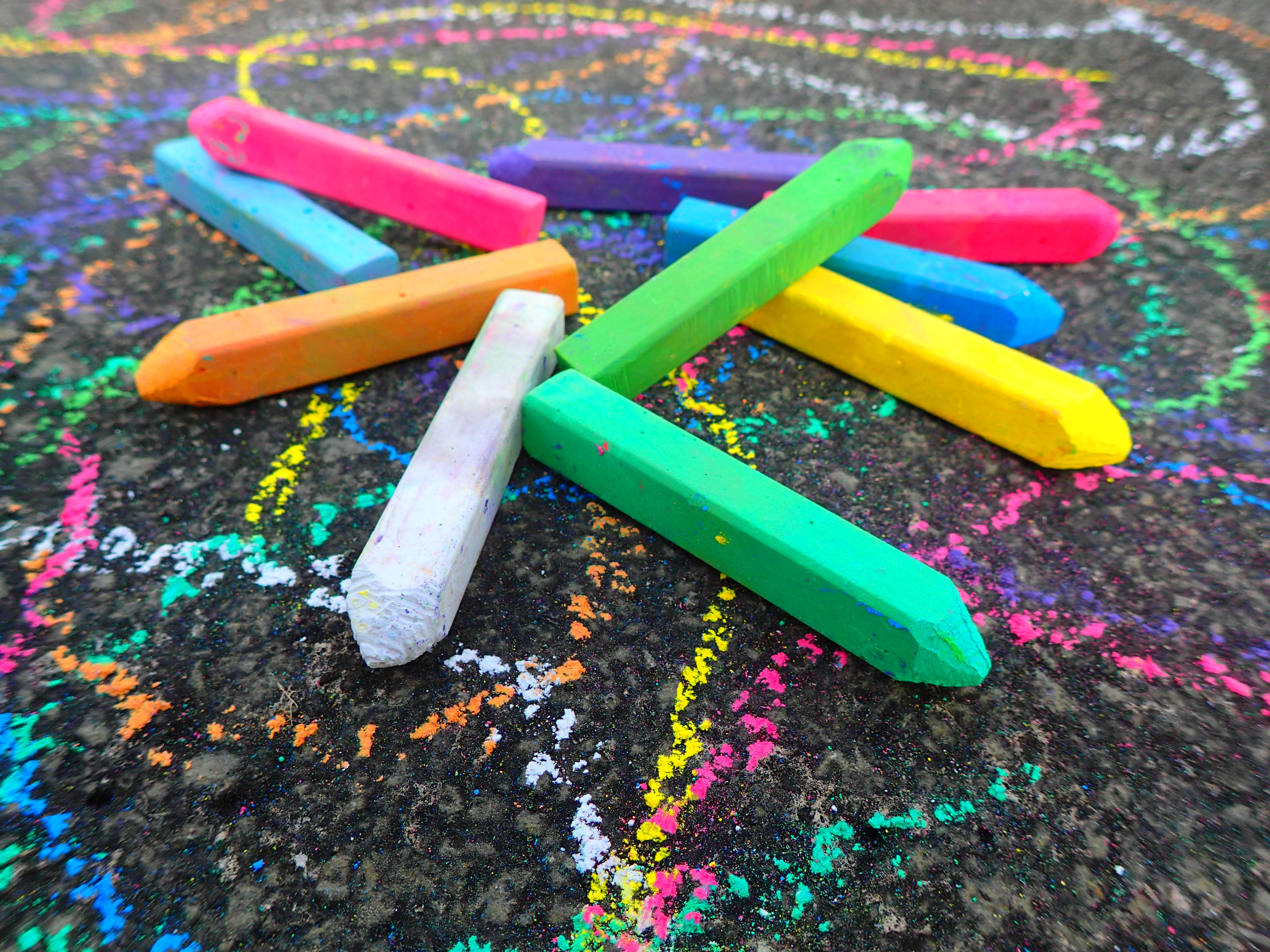 Chalk sticks of multicolor laying on ground