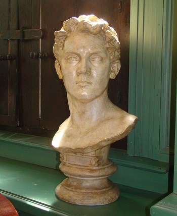 A plaster bust of a man head's with short hair.