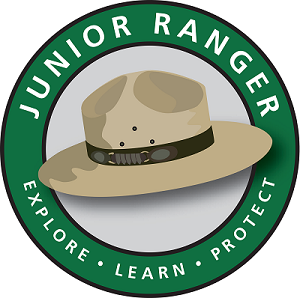 A green circle with a tan ranger hat in the middle with the words, "explore, learn, protect"