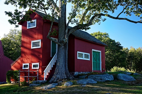 Weir Studio A red building with green doors.
