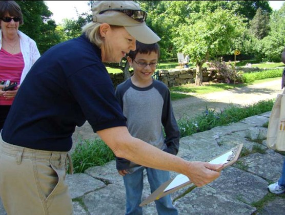 A Weir Farm Volunteer Admires a Young Artist's Painting