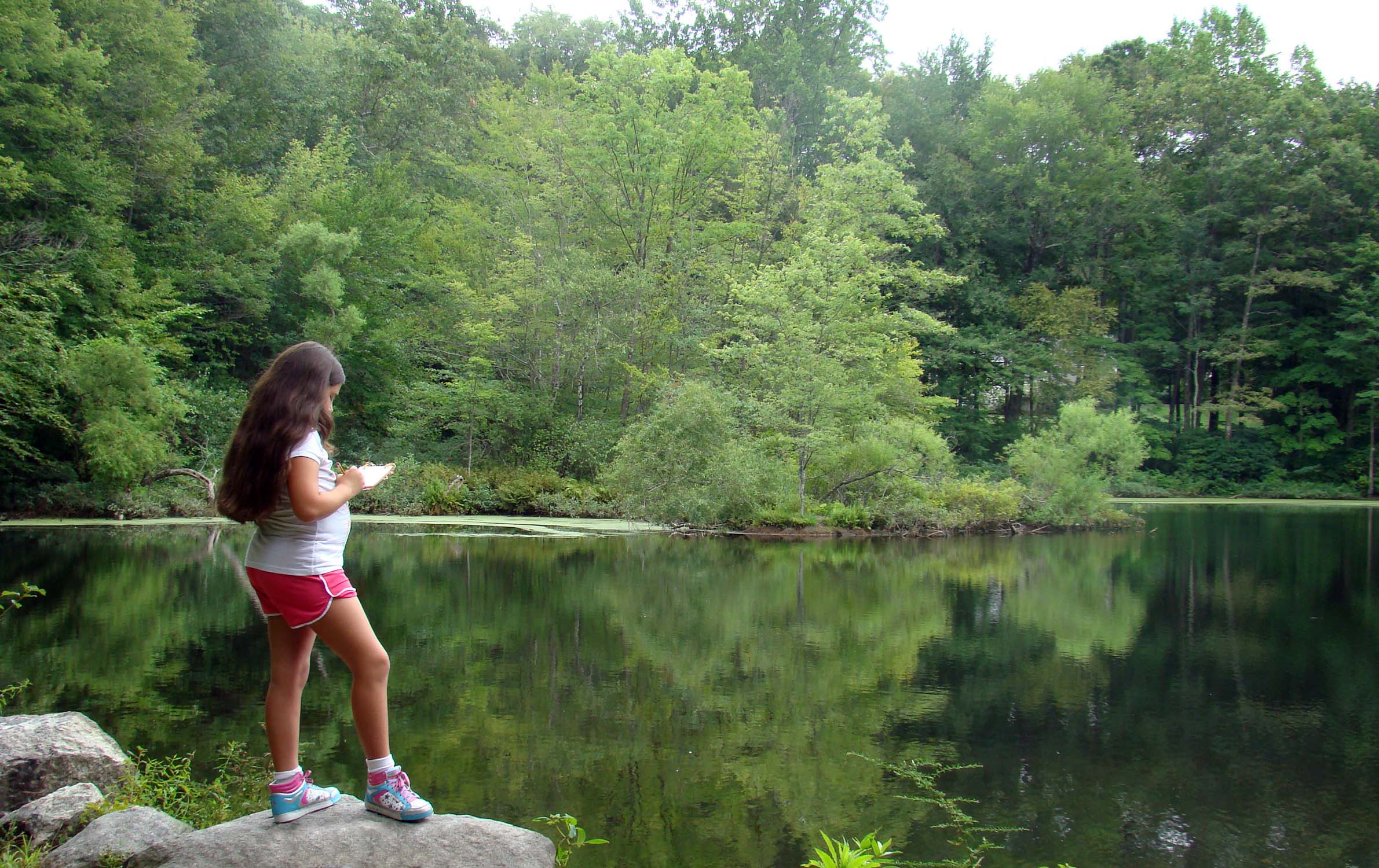 A young visitor enjoys solitude at Weir Pond A young visitor enjoys solitude at Weir Pond