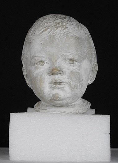 A sculpture of a young boy.