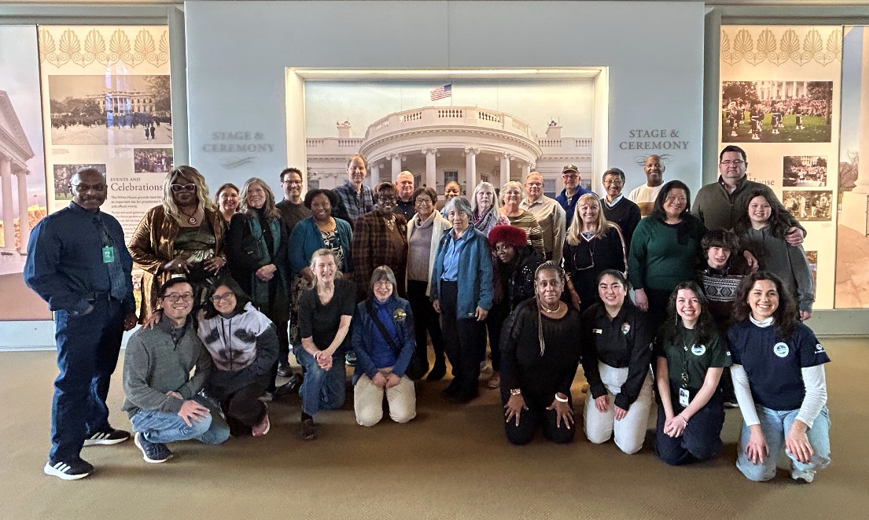 Group photo of WHHO volunteers and staff inside the White House Visitor Center