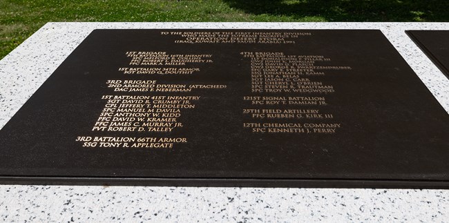 A bronze plaque lists the names of soldiers by unit.