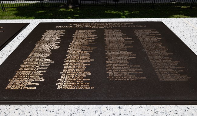 A bronze plaque with many names on it.