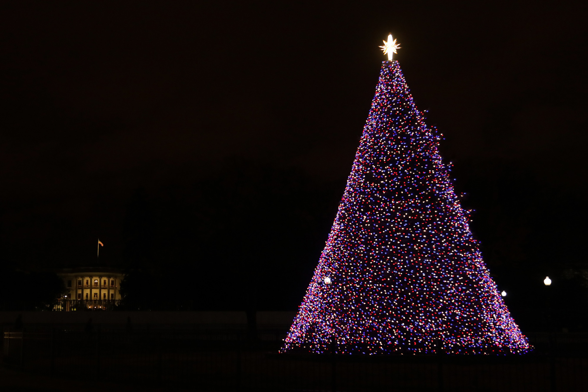 The lit National Christmas Tree with the White House in the background.